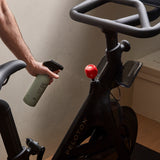 Guests on Earth All-Purpose Cleaner spritzed onto an exercise bike, wiping down handlebars for a fresh, streak-free clean