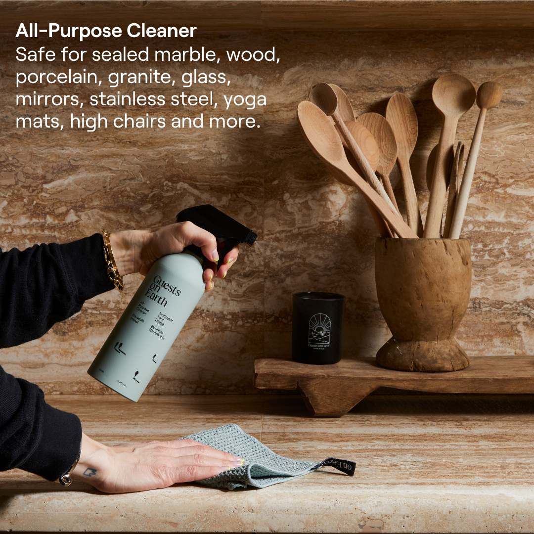 Guests on Earth All-purpose cleaner sprayed on countertop as it’s wiped clean in a kitchen