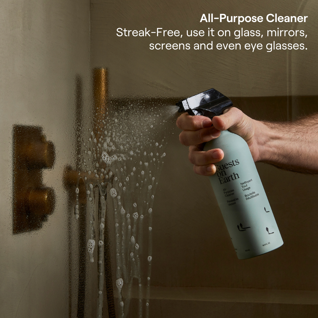 Guests on Earth All-Purpose Cleaner sprays shower glass for a streak-free clean