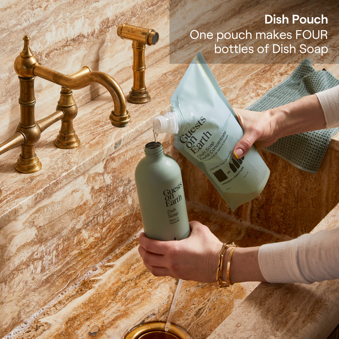 Guests on Earth Dish Pouch refill poured into dish soap bottle at marble sink, making multiple bottles