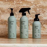 Guests on Earth non-toxic cleaning products: dish soap, all-purpose spray, and foaming hand soap bottles on a marble counter