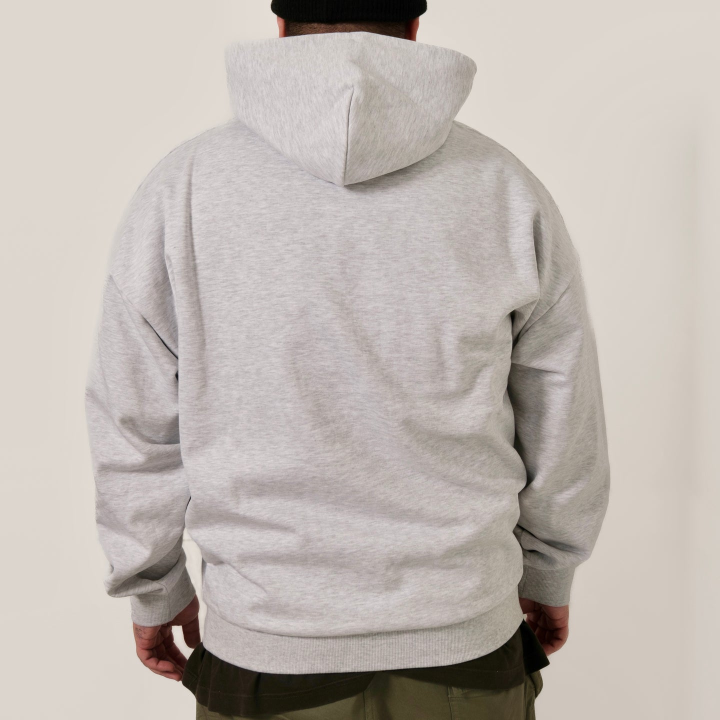 Guests on Earth Hoodie back view in heather grey, relaxed fit with hood up, clean unbranded back panel