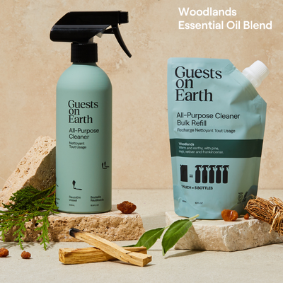 Guests on Earth all-purpose cleaner and bulk refill in a warm Woodlands essential oil blend product display.