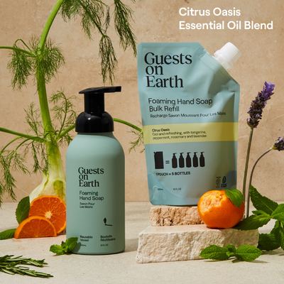 Guests on Earth foaming hand soap and bulk refill in a bright Citrus Oasis essential oil blend product display.