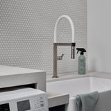 Guests on Earth All-Purpose Cleaner beside a utility sink and washer in a bright laundry room, ready for quick wipe-downs